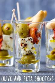 This quick and easy spread recipe comes out looking fancy, but it's just a mix of tangy cream cheese, butter, garlic, and herbs. Olive And Feta Shooters Recipe Appetizer Addiction