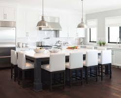 A breakfast table attached to the kitchen island offers additional seating and tabletop space. 10 Beautiful Kitchen Island Table Designs Housely