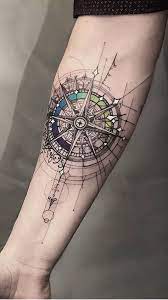 This realistic forearm ink art is created with a lighting candle and a red rose that is centered around a retro compass. 170 Compass World Map Tattoo Ideas Map Tattoos World Map Tattoos Tattoos