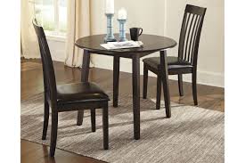 There is one large coffee table that has a pinewood top on it, and four sectionals that go beneath it with a leather top. Hammis Dining Table And 2 Chairs Set Ashley Furniture Homestore