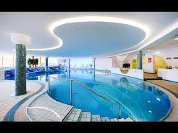 The first photograph at the top is an image of the inside of this meticulously designed indoor pool with rock wall, plants, wood ceiling and wood paneling along one wall. Modern Indoor Swimming Pool Designs Youtube