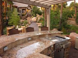 The table complements the color of the stone and encloses the entire space as an outdoor dining area with plenty of seating. Outdoor Kitchen Island Grills Pictures Ideas From Hgtv Hgtv