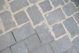 Using a broom handle or some other blunt object, tap on the pavers. How To Use Polymeric Sand To Block Weeds In Our Paver Patio Young House Love Sand Patio Paver Patio Brick Paver Patio