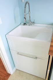 Functional acrylic utility sink with a compact cabinet underneath for extra bathroom storage. Ceramic Laundry Sink Ideas On Foter
