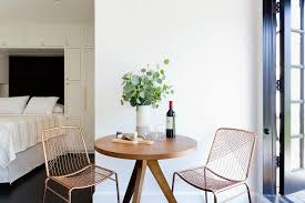 All furniture is crafted from solid wood construction, features s shape feet to serve and support. Round Wood Accent Table With Rose Gold Chairs Transitional Bedroom