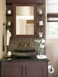 Glamorous brown and gold master bathroom features a sheepskin vanity stool placed at a chocolate brown drop down vanity accented with brass hardware and fixed beneath a window against marble hexagon wall tiles. How To Decorate A Bathroom In Shades Of Chocolate How To Organize