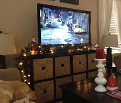 Don T Have A Fireplace To Decorate With Garland I Used Our Tv Stand Tv Stand Christmas Decor Garland Decor Christmas Decorations Apartment