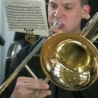 Musician Third Class (PO3) Rob Vuono, left, and Musician Second Class (PO2)  Erik Swanson, members of the 6th Fleet Band, the "Diplomats" play their  instruments during a performance