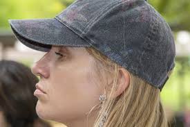 Young Attractive Woman with Blond Hair and a Worn Cap