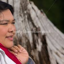 Stock Photo: Young Asian American Woman Holding Pine Branch