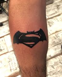 The tattoo shows superman crouching down with angel wings and behind him is a light silhouette of the s symbol and the words dc below. Updated 45 Heroic Superman Tattoos August 2020