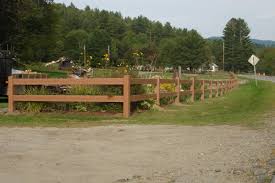 Split rail fence under blue sky. Middlebury Fence Split Rail Fencing In Vermont