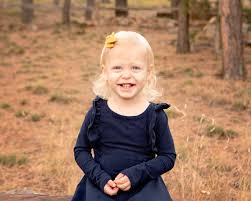 This little girl has the greatest smile! This family has a special bench  they have their portraits taken at every year. I'm so glad we were able to  fit that into their