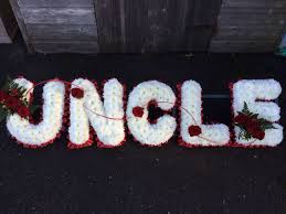 One option is to incorporate personal items into beautiful floral displays. Funeral Flowers Name Tributes