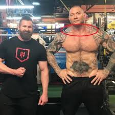 Dave bautista poses at his tampa office with a painting by meaghan farrell scalise. Dave Bautista S 33 Tattoos Their Meanings Body Art Guru
