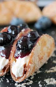 Spread mixture into the pan lined with lady fingers. Blueberry Cheesecake Tacos This Is A Recipe For Very Tasty Dessert Tacos If You Ask Me Crunchy Tortilla Shel Dessert Recipes Dessert Taco Blueberry Recipes