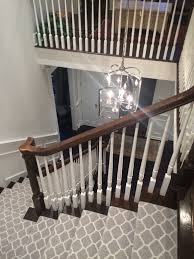 In this version, the homeowner just uses wood stain and white paint to make the stairs feel fresh again. Transitional Staircase With Patterned Carpet Runner Stanton S Carnegy In Platinum Stair Carpet Transitional Living Rooms Transitional Decor Transitional House