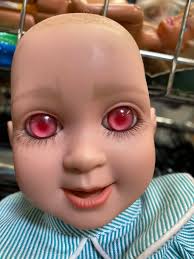 Custom doll resembling owner with pink eyes