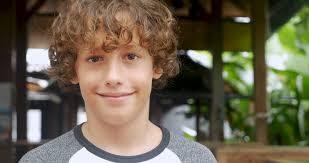 This bun style suits with girls who have thick hair. Portrait Of A Cute Young 11 12 Year Old Boy With Curly Hair Smiling And Looking At The Camera Stock Video Footage Storyblocks