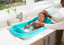 Child playing with water and soap bubbles in sunny kitchen with window. The 10 Best Baby Bath Tubs Parents