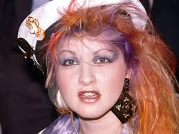Cyndi Lauper burst into the spotlight during the early 1980s with her  infectious energy, bold style, and a voice that quickly captured the hearts  of millions. Her iconic songs like "Girls Just