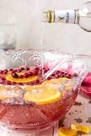A Punch Bowl Filled With Easy Vodka Punch Recipe Holiday Punch Recipe Punch Recipes Christmas Drinks Alcohol Recipes