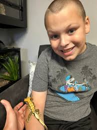 Nonverbal autistic boy bonds with bearded dragon