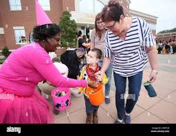 Nashville United Methodist Church Weekday School student Jackson Winstead,  3, center, receives candy from Angela Mangum, left, while walking with his  grandmother Cynthia Jackson, right, and mother Lauren Winstead
