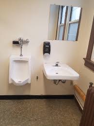 urinal right next to the sink without