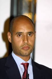 Image of Frank Raines listens to President-Clinton during a press  conference held
