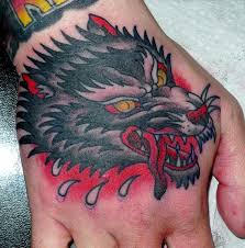Yellow Eyes Traditional Wolf Tattoo On Right Hand Traditional Tattoo Traditional Style Tattoo Hand Tattoos