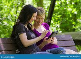 Girlfriends Sharing an Etablet on Park Bench, Horizontal Stock Photo -  Image of technology, lesbian: 33415954