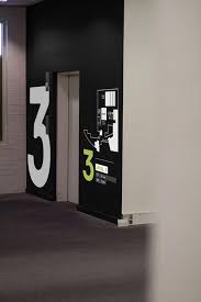 Oversized Numbers And Floor Plan Next To An Elevator Visit The Slowottawa Ca Boards Wayfinding Signage Signage Wayfinding Design