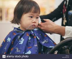 Asian Baby Girl Do Hair Cut First Time In Hairdressing Shop Stock Photo Alamy