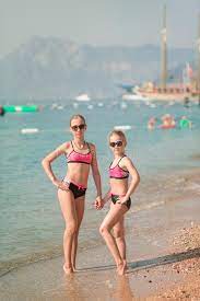 Happy Young Girls at the Seaside Sunbathing Stock Image - Image of family,  lifestyle: 124712541