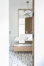 You can orient the tic tac layout vertically or horizontally, depending on preference, though the vertical orientation does a. White And Gray Marble Chevron Pattern Powder Room Wall Tiles Modern Bathroom