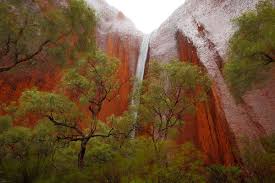 A rare waterfall at uluru in central australia. Tourists Spot Rare Phenomenon Of Uluru Waterfalls The Independent