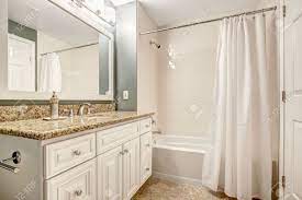 This beautiful natural stone vanity top is attached to a rectangular white vitreous china undermount bowl with a safety overflow hole. White Bathroom Vanity Cabinet With Granite Top And Mirror Aqua Stock Photo Picture And Royalty Free Image Image 31306094
