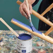 Annie Sloan painting a dining chair using Chalk Paint in Napoelonic Blue 1000