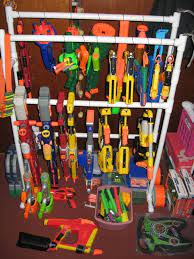 This storage rack can hold up to 20 blasters of different sizes with shelves, drawers, rail mounts and hooks. Nerf Storage Ideas A Girl And A Glue Gun