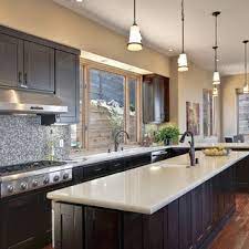 The combination of oak color with the darkness of the countertop will be beautiful. Dark Cabinets Light Countertop Houzz