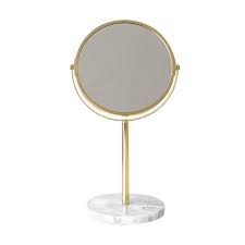 Offset the mirror with other gold accent pieces, such as sculptures and clocks, for the finishing touches. Dilas Home Metallic 2 Sided Gold Rose Gold Marble Decorative Tilted Makeup Vanity Mirror Stand