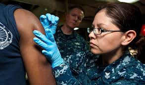 Hospital Corpsman 1st Class Diana Rodriguez administers a smallpox vaccine  to a patient aboard USS John C. Stennis (CVN 74) during immunizations.