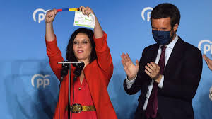 A man walks past a campaign poster for isabel diaz ayuso, the head of madrid's regional. Jv375z6fyiaaom