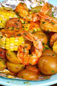 Closeup Of Shrimp Foil Packets On A Serving Plate Showing Juicy Jumbo Shrimp Potatoes Sausage Potatoes And Corn With Cajun Seasonin Bbq Recipes Recipes Food