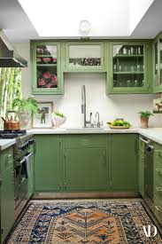 If you love gray kitchens but you also love rich wood tones, try these ideas for two tone wood and gray kitchen cabinetry. Step Inside Dakota Johnson S Midcentury Modern Home Green Kitchen Kitchen Interior Kitchen Remodel