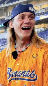 Dakota “Stilts” Albritton of the Savannah Bananas “keeps cool” as his  teammate attempts to distract him during his interview., Interview