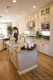 Antique White Kitchen With Wood Floors And An Island Sink Antique White Kitchen Antique White Kitchen Cabinets Simple Kitchen Remodel