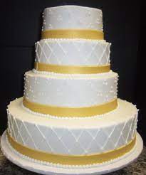 Dots And Crisscross Designs And Gold Fondant Ribbon On Our White Buttercream Iced Cake Traditional Wedding Cakes Cake Ice Cake