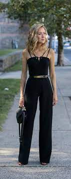 Black Sleeveless Wide Leg Jumpsuit Gold Waist Belt Block Heel Sandals Black Handbag Curled Hairstyle Black Halo Fashion Black Jumpsuit Wide Leg Jumpsuit